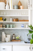 Accessories in natural shades on kitchen shelves
