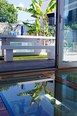 Glass floor next to open door and view of table on terrace