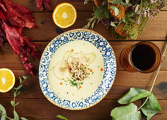Citruses and wine cream soup amidst floral twigs