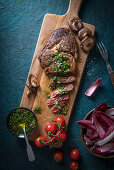 Ribeye steak with chimichurri sauce, mushrppms and salad