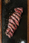 Medium rare slices steak on table
