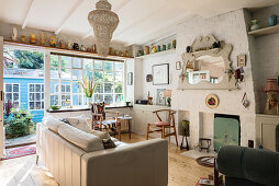 White leather sofa and fireplace in brick chimney breast in living room