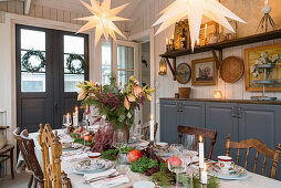 Festively set table in dining room decorated for Christmas