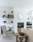 Shelves flanking built-in fireplace in white and beige living room