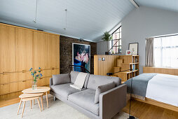 Modern, open-plan interior with fitted cupboards and staircase shelves