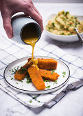 Vegan 'fish fingers' made from soya protein with a creamy herb sauce