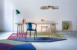 Glass table with wooden frame on octagonal striped rugs