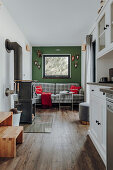 Tartan sofa against green wall and wood-burning stove in tiny house