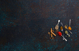 Spices On Spoons on Dark Background