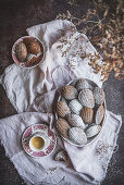 Appetizing sweet cookies served with powdered powder on table with cup of tea