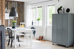 Industrial-style dining room with rustic board wall