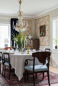 Set dining table and dark chairs in classic dining room