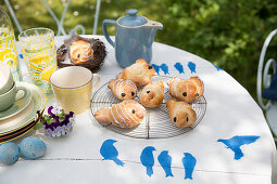 Easter breakfast in garden with pastries and handmade table decorations