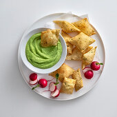 Fava bean cream with fried herb pillows and radishes