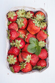 Fresh strawberries in a paper bowl