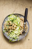 Spelt spaghetti with zucchini and tofu in sesame sauce, vegan