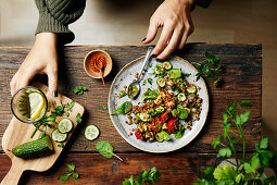 Lentil salad with cucumber, tomato, pesto and baby spinach