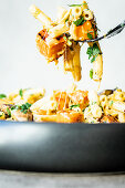 Cheese macaroni with mushrooms and pumpkin (close-up)