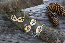 Necklace and bracelets with pendants made from discs of wood decorated with poker work