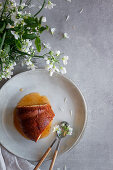 Top view of delicious Bundt cake with apple sauce placed on table