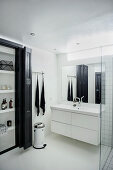 Fitted cupboard in black-and-white bathroom