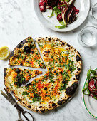 A herb and Pecorino pizza baked in a wood-fired oven
