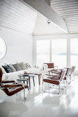 Leather armchairs in white, light-flooded living room