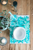 Handmade place mats with turquoise watercolour effect on wooden table