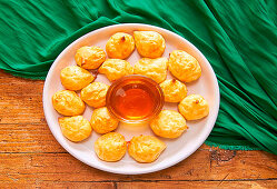 Cheese Puffs, served with honey being prepared