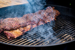 Marinated beef ribs being grilled
