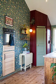 Pantry in corner of country-house kitchen with floral wallpaper