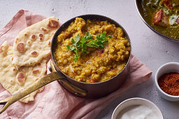 Indian red lentil curry soup dal with rice naan (vegan)