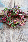 Wreath of hawthorn berries, ling and leafy branches