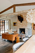 Buffalo head above open fireplace in rustic open-plan interior