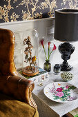 Arrangement of stuffed bird under glass cover and glamorous, vintage-style ornaments