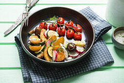 Roasted potatoes with vegetables, mushrooms and vegan yogurt dressing