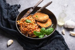 Aubergine cutlets with ribbon noodles in tomato sauce