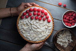 Coconut tart with coconut chips and raspberries