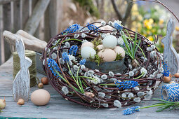 Wreath of kitten willow and grape hyacinths, Easter eggs and Easter bunnies as decoration