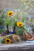 Bouquets of sunflowers, maidens in the countryside and ears of corn in an antique glass tray, pretzels, beer mugs, plates and cutlery