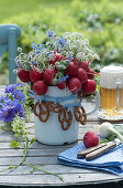Edible bouquet made from radishes, borage and beaver nelle, decorated with pretzels