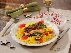Salmon with a melba toast crust on a bed of tagliatelle