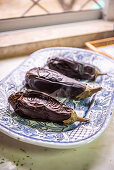 Roasted aubergines on a blue tray
