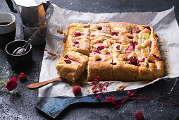 Vegan rhubarb and raspberry cake baked in a tray, sliced