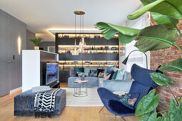 Illuminated shelving in glamorous living room decorated in blue and grey