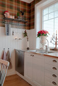 Tartan wallpaper above wainscoting in country-house kitchen