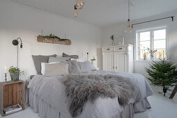 Grey fur on bed with valance in shabby-chic bedroom
