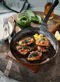 Saltimbocca in a rustic pan with wild garlic pesto