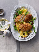 Chicken escalope with an orange and fennel crust with rocket and tagliatelle