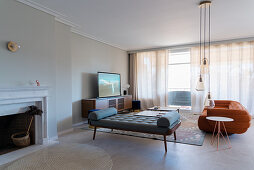 Chaise longue, suede sofa and TV cabinet in elegant living room